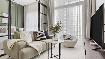 Design Apartment, 1 Bedroom, Balcony, City View | Living area | 50-inch LED TV with digital channels