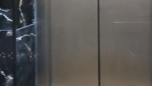 En metal elevator dør med spejllignende overflade.