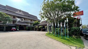 A hotel with a traditional architectural style, featuring multiple balconies and a large entrance area. - Sawadeelanna Hotel (Nan)