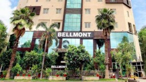 A multi-story hotel named Bellmont with a modern architectural design, featuring large windows and a prominent entrance. - FabHotel Prime Bellmont (Noida)
