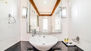 A modern bathroom with a large white sink, a mirror, and a towel rack. - FabHotel Prime Rapid Lakme Executive (Pune)