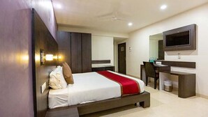A modern hotel room with a bed, a desk, and a TV. - FabHotel Prime Sukh (Mumbai)