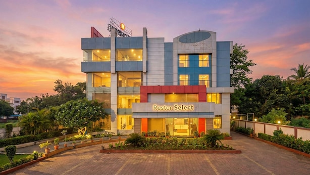 A multi-story hotel with a modern architectural design, featuring a prominent 'Rester.Select' sign on the ground floor. - FabHotel Prime Rester Select Chakan (Rajgurunagar)