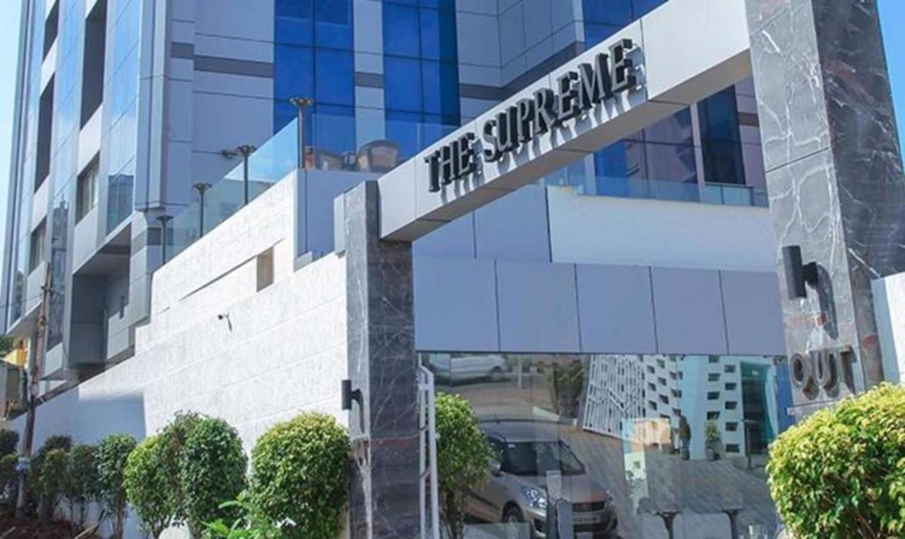 A modern building with a sign reading "THE SUPREME".