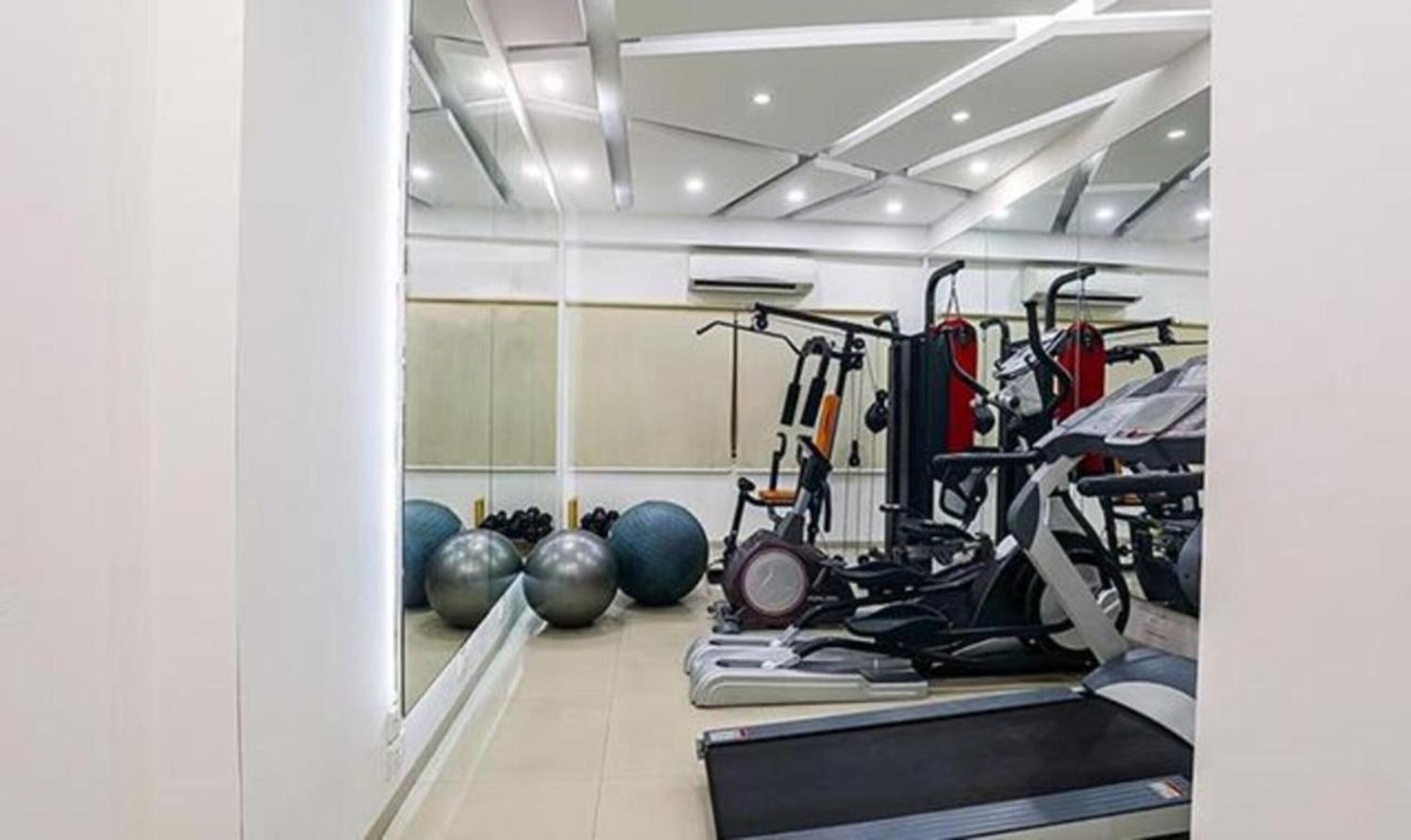 A gym with treadmills, exercise balls, and weight machines.