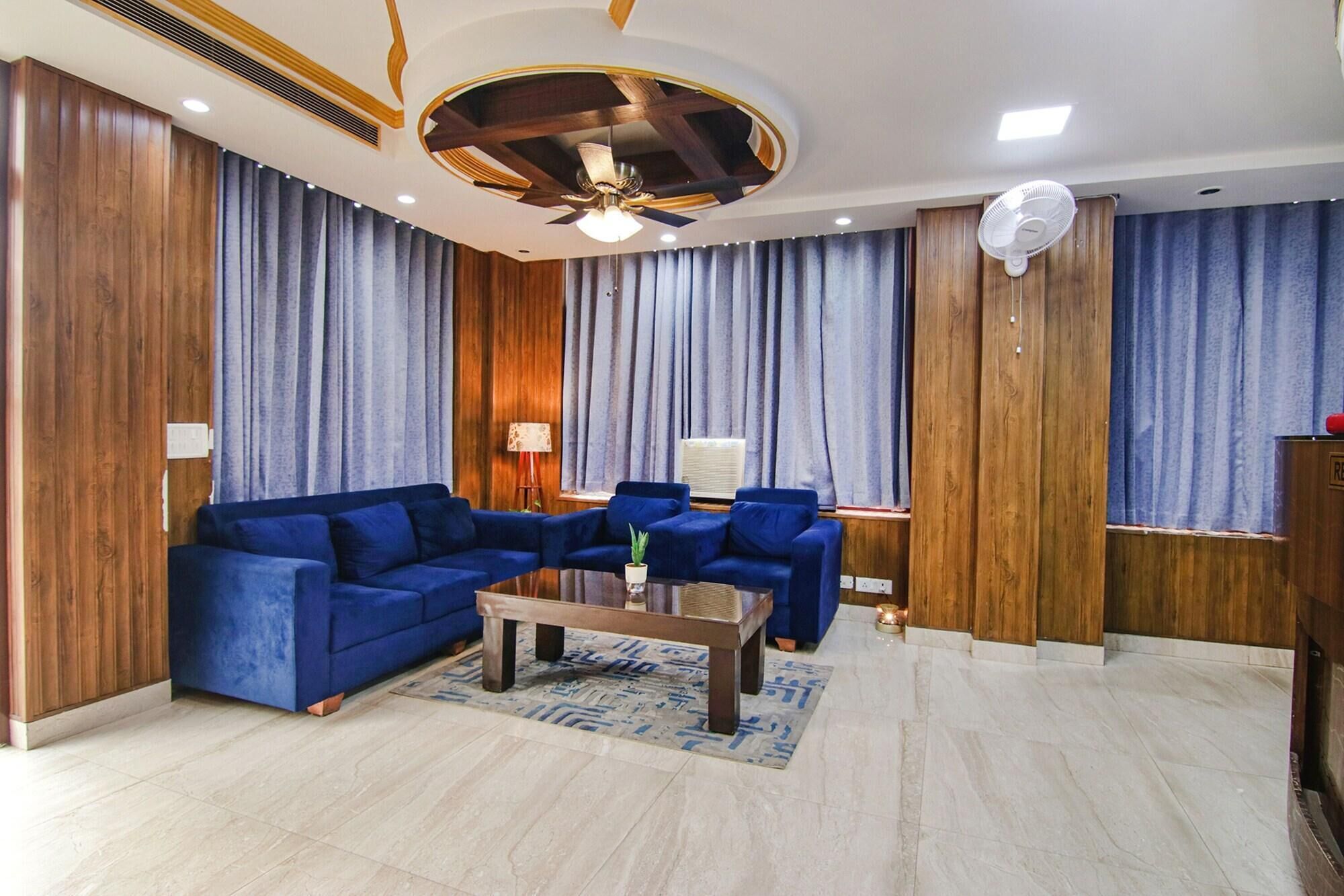 A modern living room with a sectional sofa, a coffee table, and a fireplace.