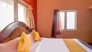 A room with a bed, curtains, and a window. - FabHotel Green Castle Resort (Kodaikanal)