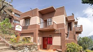 A multi-story building with a red door, a balcony, and a sign that reads "A Block". - FabHotel Green Castle Resort (Kodaikanal)