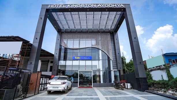 The entrance to Hotel Kingston Ayodhya with a modern design, featuring a large archway and a sign for 'fob hotels'.