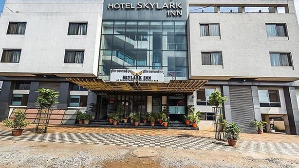 A modern hotel building with a prominent sign reading "Hotel Skylark Inn". - FabHotel Skylark Inn (Nashik)