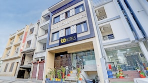 A hotel with a modern facade, multiple balconies, and a sign reading "fabHOTELS." - FabHotel SMR (Agra)