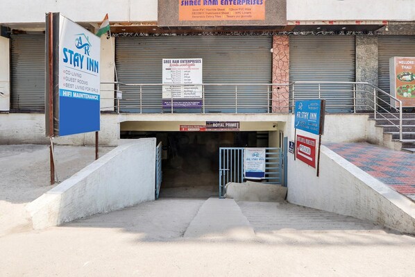 A hotel entrance with a sign for 'AR Stay Inn' and 'Sree Ram Enterprises'.
