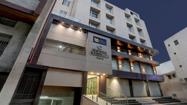 A modern hotel building with a sign reading "fabHOTELS HOTEL SIMRAN". - FabHotel Prime Simran (Rajkot)