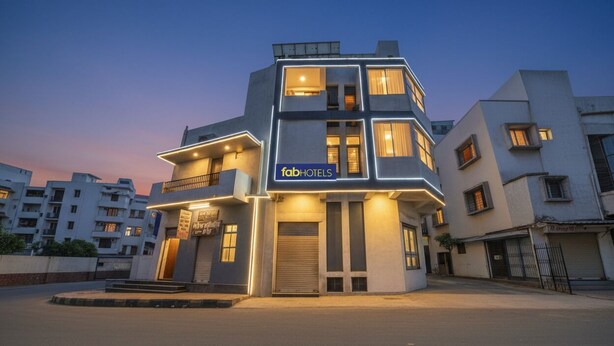 A modern multi-story building with a sign for 'fabHOTELS'. - FabHotel SK (Rajkot)