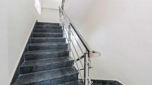 A staircase with black steps and a metal handrail. - Via Dream Connect - Narsingi (Hyderabad)