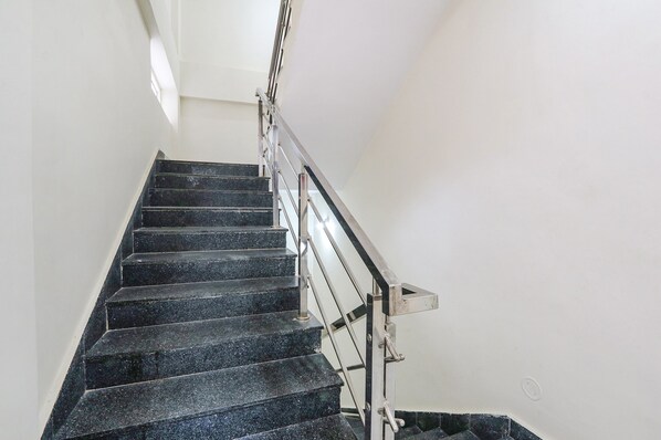 A staircase with black steps and a metal handrail. - Via Dream Connect - Narsingi (Hyderabad)