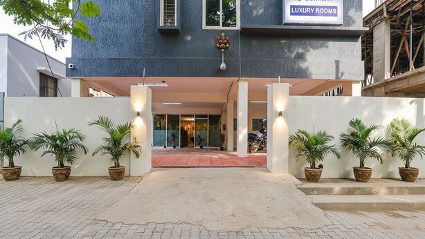 A building entrance with a sign indicating 'LUXURY ROOMS'. - Via Dream Connect - Narsingi (Hyderabad)