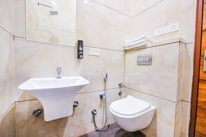 A bathroom with a sink, toilet, and shower. - FabHotel K9 Orbit (Ludhiana)