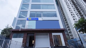 A hotel with a modern facade, a prominent sign, and a staircase leading to the entrance. - FabHotel Silver Key (Anekal)