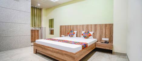 A modern bedroom with a wooden bed, a nightstand, a ceiling fan, and a bathroom with a shower curtain.