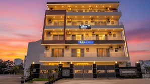 A multi-story hotel with balconies, air conditioning units, and a sign for 'Sky' and 'Fab Hotels'. - FabHotel Sky - Nr. Sapphire 83 Mall, Manesar (Gurugram)