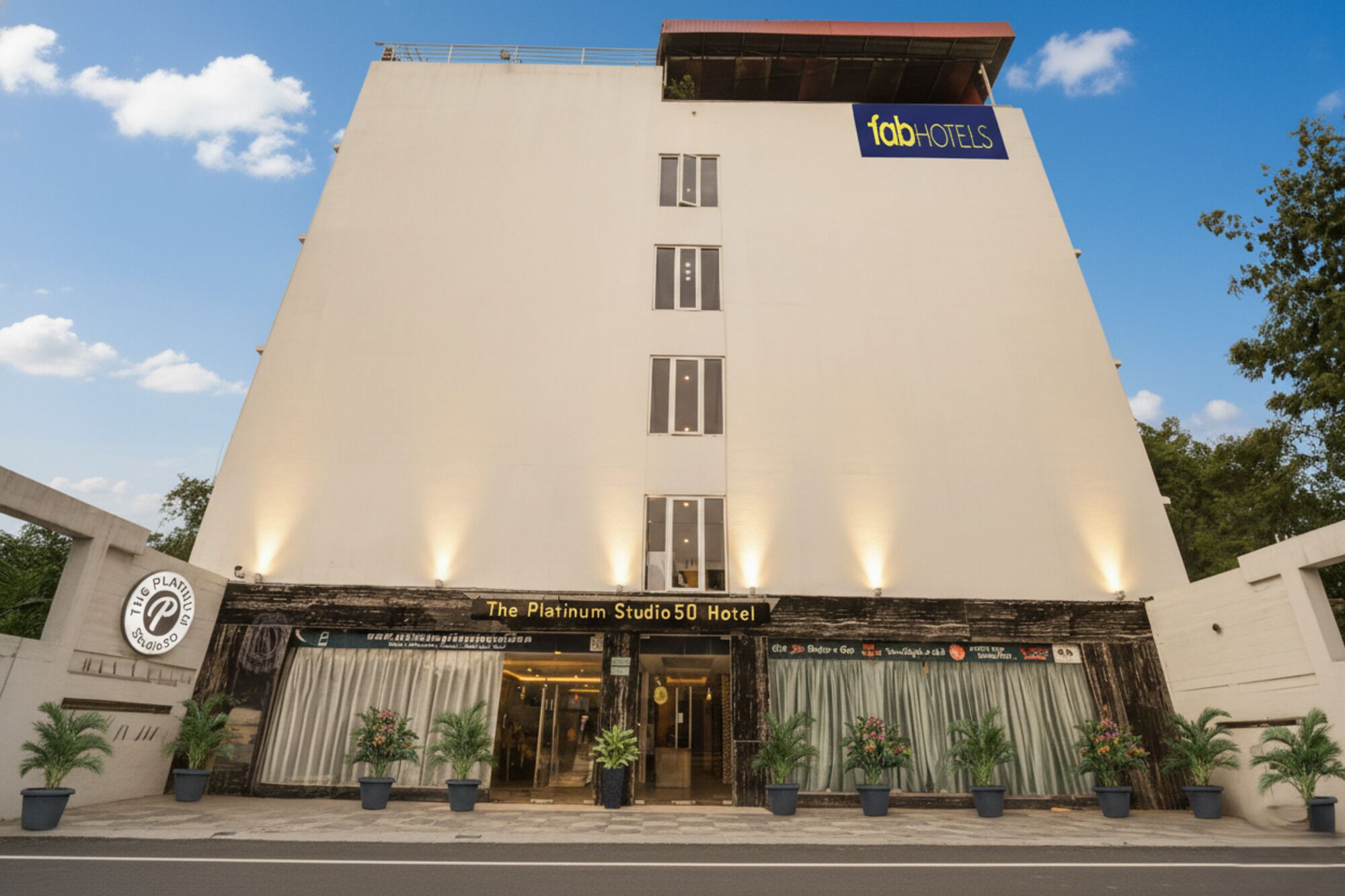 The Platinum Studio 50 Hotel with a modern facade, a prominent 'fabHOTELS' sign, and a series of windows.
