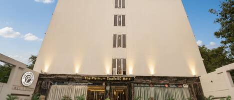 The Platinum Studio 50 Hotel with a modern facade, a prominent 'fabHOTELS' sign, and a series of windows.