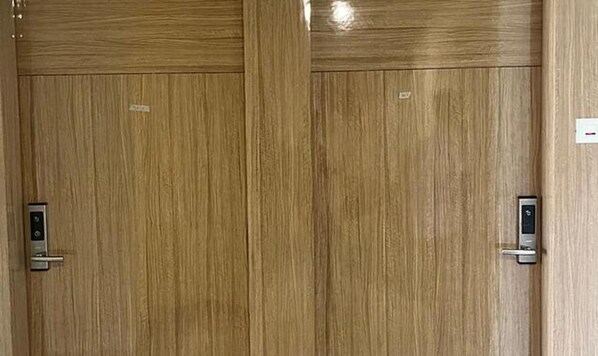 A wooden door with a keypad lock. - FabHotel Prakash (Ujjain)