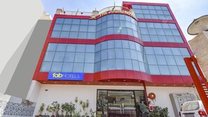 A hotel with a modern facade, large windows, and a sign reading "fabHOTELS". - FabHotel Jugnu (Kharar)