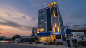 A modern hotel building with a prominent 'fab hotels' sign, multiple floors, and a staircase leading to the entrance. - FabHotel VK’s Bahadurpally- Nr. Mahindra University, Bahadurpally, Jeedimetla (Hyderabad)