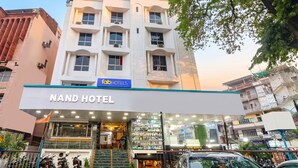 A hotel entrance with a sign for 'NAND HOTEL' and a visible storefront with various products. - FabHotel Nand (Patna)