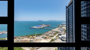 A coastal port with industrial buildings and cranes, viewed from a high vantage point. - Capital O 90998 Margo Home (Kota Kinabalu)