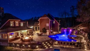 A house with a swimming pool, outdoor seating, and a stone pathway. - Luxury Smokies Home with Backyard Paradise (Sevierville)