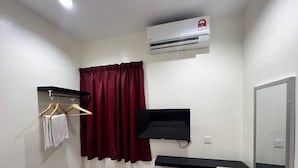 A small, clean room with a bed, a TV mounted on the wall, a window with a curtain, and a desk with a chair. - OYO 90994 Hotel Golden Mouse (Ipoh)