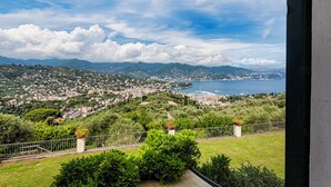 A coastal town with a view of the sea and mountains.