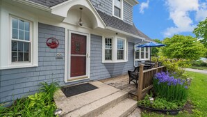A two-story house with a front porch, a mailbox, and a number 406 sign. - Cozy Corner Cottage| Beach Access & Historic Charm (Sheboygan)