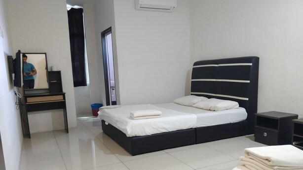 Un dormitorio moderno con una cama grande, un escritorio y un espejo.
