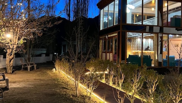 A modern building with large windows and a reception area visible inside. - Thongsal (Leh)