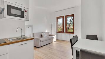 Apartment, 1 King Bed with Sofa bed, Non Smoking | Living area | Flat-screen TV