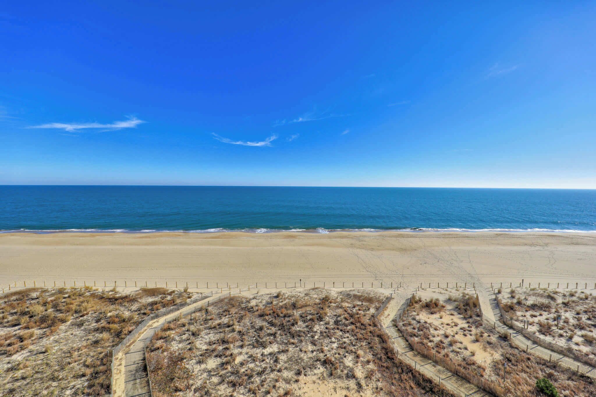 A beach with a clear sky and calm sea.