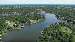 An aerial view of a lakeside community with houses and boats. - Safari Tent A at Eden Reserve - Near Ark (Williamstown)