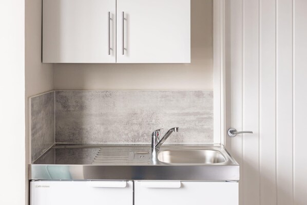 Fridge, microwave, electric kettle, cookware/dishes/utensils