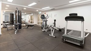 A gym with various exercise equipment, including a treadmill, stationary bikes, and weight machines. - Marvelous Manly with Gym and Sauna (Manly)