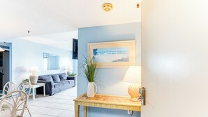 A living room with a sofa, chairs, a coffee table, and a painting on the wall. - Beachfront Condo w/ Pool at Myrtle Beach Resort! (Myrtle Beach)