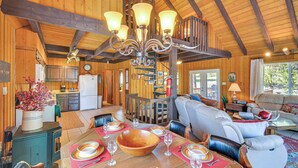 A wooden cabin interior with a dining area, kitchen, and living room. - 'mccall Creekside Cabin' Secluded Buena Vista Gem! (Buena Vista)