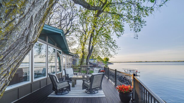 A deck with outdoor furniture, a railing, and a view of the water. - Dreamy Lake Poinsett Cabin w/ Deck, Dock & Views! (Arlington)