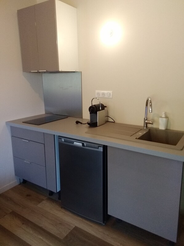 A compact kitchen with a dishwasher, a sink, and a countertop.