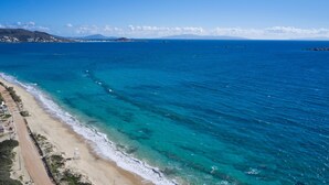A coastal view with a sandy beach and clear blue waters. - Maestro Villas Naxos (Naxos)