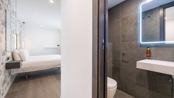 Shower, designer toiletries, hair dryer, towels