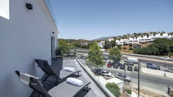 Relax on the balcony with comfortable sun loungers and take in the views of the surrounding area.